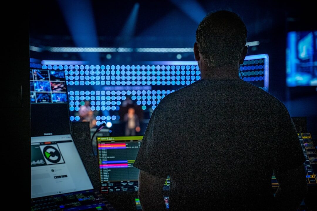 Live broadcast control room with multiple screens